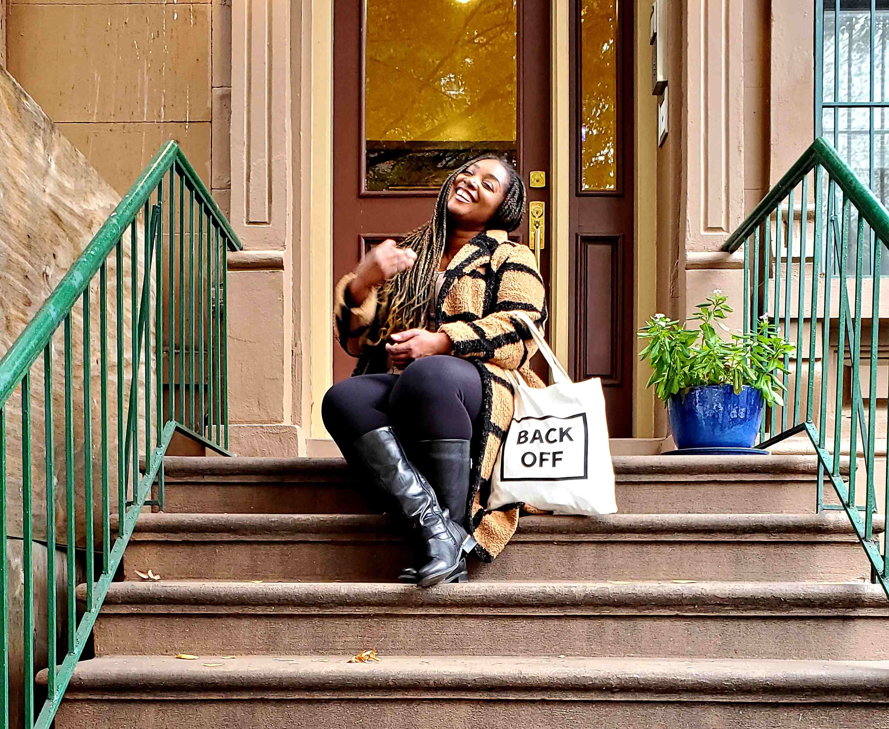 La sitting on the stoop of the Harlem brownstone